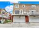 This townhome features multiple balconies above attached garages and brick accents at 253 1St Nw St, Carmel, IN 46032