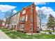 Beautiful townhome with a brick facade, balcony, and well-manicured lawn at 253 1St Nw St, Carmel, IN 46032