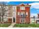 Inviting townhome features a classic brick facade, lush lawn, and well-maintained landscaping at 253 1St Nw St, Carmel, IN 46032