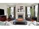 Cozy living room featuring a marble fireplace, modern artwork, and hardwood flooring at 253 1St Nw St, Carmel, IN 46032