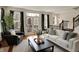 Bright living room with French doors leading to a balcony, hardwood floors, and fireplace at 253 1St Nw St, Carmel, IN 46032