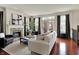 Elegant living room with fireplace, hardwood floors, and French doors to the balcony at 253 1St Nw St, Carmel, IN 46032