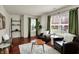 Inviting living room with hardwood floors, matching chairs and lots of natural light from two windows at 253 1St Nw St, Carmel, IN 46032