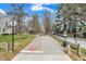 Scenic view of the paved Monon Greenway trail with trees and street parking on a sunny day at 253 1St Nw St, Carmel, IN 46032