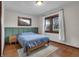Serene bedroom with hardwood floors, natural light, and a soothing blue accent wall at 2737 Napoleon St, Indianapolis, IN 46203
