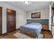 Calm bedroom with wood floors, natural light, minimalist decor, and paneled green accent wall at 2737 Napoleon St, Indianapolis, IN 46203