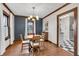 Cozy dining room featuring hardwood floors, a stylish light fixture, and a navy accent wall at 2737 Napoleon St, Indianapolis, IN 46203