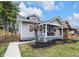 Charming home featuring a welcoming front porch with seating and well-maintained landscaping at 2737 Napoleon St, Indianapolis, IN 46203