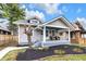 Charming home featuring a welcoming front porch with seating and well-maintained landscaping at 2737 Napoleon St, Indianapolis, IN 46203