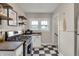 Well-lit kitchen with stainless steel gas range, black and white tile, and lots of natural light at 2737 Napoleon St, Indianapolis, IN 46203