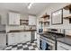 Modern kitchen featuring stainless steel appliances, white cabinetry, and stylish black and white flooring at 2737 Napoleon St, Indianapolis, IN 46203