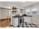 Open kitchen area with stainless steel range, black and white tile flooring, and ample counter space at 2737 Napoleon St, Indianapolis, IN 46203