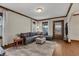 Inviting living room featuring a comfortable gray sectional sofa, natural light, and hardwood floors at 2737 Napoleon St, Indianapolis, IN 46203