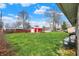 Large backyard with lush green grass and a storage shed, perfect for outdoor activities and storage at 318 Winfield St, Greenfield, IN 46140