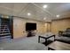 Finished basement with comfortable seating, carpeted floor, and mounted television for relaxation and entertainment at 318 Winfield St, Greenfield, IN 46140