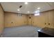 Large carpeted basement with two windows allowing natural light and views of the outdoors at 318 Winfield St, Greenfield, IN 46140