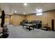 Carpeted basement with comfortable seating and mounted television, creating a cozy entertainment space at 318 Winfield St, Greenfield, IN 46140