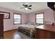 Cozy bedroom with two windows, wood floors and a ceiling fan at 318 Winfield St, Greenfield, IN 46140