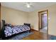 Bedroom with wood floors, adjacent bathroom and a ceiling fan at 318 Winfield St, Greenfield, IN 46140
