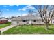 Attractive single-story home featuring a stone exterior, attached garage, and welcoming front entrance at 318 Winfield St, Greenfield, IN 46140