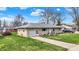 Charming single-story home with stone facade, attached garage, and well-maintained front yard at 318 Winfield St, Greenfield, IN 46140
