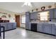 Well-lit kitchen featuring gray cabinetry, tiled backsplash, and ample counter space for cooking at 318 Winfield St, Greenfield, IN 46140