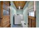 Well-lit laundry room with washer, dryer, and convenient access to the outside at 318 Winfield St, Greenfield, IN 46140
