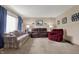 Bright living room with plush furniture, carpeted floors, and tasteful wall decor at 318 Winfield St, Greenfield, IN 46140