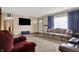 Spacious living room with neutral decor, featuring a floral sofa and large front window at 318 Winfield St, Greenfield, IN 46140