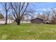 Full backyard view of house with garage and large trees at 322 S Boehning St, Indianapolis, IN 46219