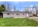 A spacious backyard featuring a well-maintained lawn and a home with a patio at 322 S Boehning St, Indianapolis, IN 46219