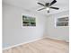 Bright bedroom with neutral paint, two windows and light colored wood-look flooring at 322 S Boehning St, Indianapolis, IN 46219