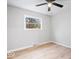 Bright bedroom with neutral paint, one window and light colored wood-look flooring at 322 S Boehning St, Indianapolis, IN 46219
