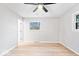 Large bedroom featuring new floors, a ceiling fan, and natural light from multiple windows at 322 S Boehning St, Indianapolis, IN 46219