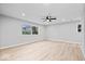 Spacious bedroom featuring new floors, a ceiling fan, and a large window overlooking the backyard at 322 S Boehning St, Indianapolis, IN 46219