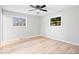 Bright bedroom with new floors, ceiling fan, and dual windows offering ample sunlight and fresh air at 322 S Boehning St, Indianapolis, IN 46219