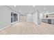 Bright open floor plan showcasing vinyl flooring, neutral walls, and seamless integration with the adjacent kitchen at 322 S Boehning St, Indianapolis, IN 46219