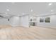 Open-concept living room showcasing luxury vinyl plank floors and neutral walls, offering a bright, airy space at 322 S Boehning St, Indianapolis, IN 46219