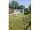Overview of a flat, grassy backyard surrounded by chain link fence at 351 N Smart St, Greenwood, IN 46142