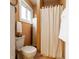 Functional bathroom featuring a toilet, shower with curtain, and bright paint at 359 N Whitcomb Ave, Indianapolis, IN 46224