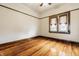 Empty bedroom with polished hardwood floors, light walls, and bright window at 359 N Whitcomb Ave, Indianapolis, IN 46224