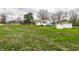 Sprawling front lawn with a view of the charming white house and multiple storage sheds at 359 N Whitcomb Ave, Indianapolis, IN 46224