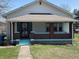 Charming single-Gathering home featuring a covered porch with brick columns and freshly painted trim at 359 N Whitcomb Ave, Indianapolis, IN 46224