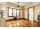 Well-lit room featuring beautiful hardwood flooring and charming vintage trim around the windows at 359 N Whitcomb Ave, Indianapolis, IN 46224
