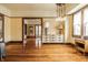 Spacious room with hardwood flooring, vintage trim, and large windows providing ample natural light at 359 N Whitcomb Ave, Indianapolis, IN 46224