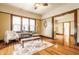 Bright living room featuring hardwood floors, natural light, and vintage ceiling fan at 359 N Whitcomb Ave, Indianapolis, IN 46224