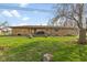 Backyard with lush green lawn and view of the rear of the home with hot tub at 3638 Redfern Dr, Indianapolis, IN 46237