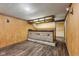 This finished basement features wood paneled walls and luxury vinyl plank flooring at 3638 Redfern Dr, Indianapolis, IN 46237