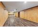 Spacious finished basement showcasing wood-paneled walls and recessed lighting at 3638 Redfern Dr, Indianapolis, IN 46237