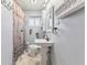 Cozy bathroom with pedestal sink, farmhouse style shower curtain, and classic fixtures at 3638 Redfern Dr, Indianapolis, IN 46237